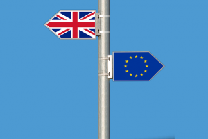 Pole with signs facing opposite ways, one with the British flag and one with the European flag